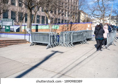 NEW YORK, NY – JANUARY 10, 2021: People Who Are Eligible And Registered Wait In Line To Get COVID-19 Vaccine At NYC Health Department Vaccine Hub At Hillcrest High School In Queens