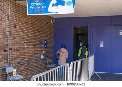 NEW YORK, NY – JANUARY 10, 2021: A Woman Who Is Eligible And Registered Enters The Hub To Get COVID-19 Vaccine At NYC Health Department Vaccine Hub At Hillcrest High School In Queens.