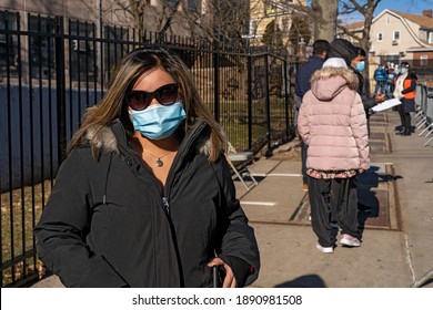 NEW YORK, NY – JANUARY 10, 2021: A Woman Who Is Eligible And Registered Waits In Line To Get COVID-19 Vaccine At NYC Health Department Vaccine Hub At Hillcrest High School In Queens.