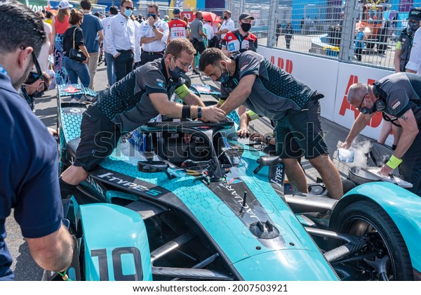 NEW YORK, NY - JULY 10, 2021: Crew members make\
last moment repairs on car no. 10 before start of the race during\
the ABB FIA Formula E Championship, New York City E-Prix Round 10,\
in Brooklyn.