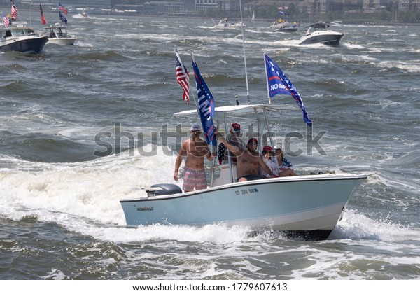 NEW YORK, NY - JULY 19, 2020: A huge flotilla of\
President Trump supporter’s boats and jetski displaying Trump 2020\
flags part of \