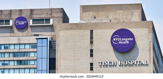 New York, NY - July 27, 2021: Purple and white Logos of NYU Langone Health attached to the brick on the side of Tisch Hospital in East Midtown Manhattan, NYC. Two Logos are visible