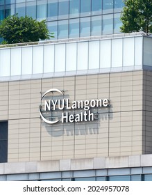 New York, NY - July 27, 2021: Logo of NYU Langone Health attached to the brick on the side of a hospital building in East Midtown Manhattan, NYC. The lettering is all in white