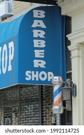 New York, NY - June 13, 2021: Local Barber Shop Store Front With Pole In New York City's Latin Community.