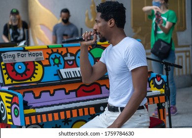 NEW YORK, NY - JUNE 19, 2020: Musician Jon Batiste speaks to gathered crowds between songs as performs live in concert on Juneteenth on the steps of the Brooklyn Public Library at the Grand Army Plaza