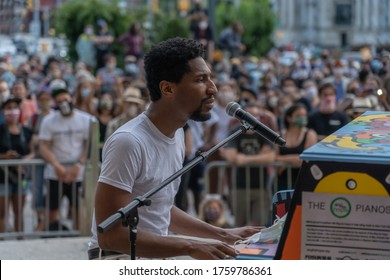 NEW YORK, NY - JUNE 19, 2020: Musician Jon Batiste performs live in concert on Juneteenth on the steps of the Brooklyn Public Library at the Grand Army Plaza.