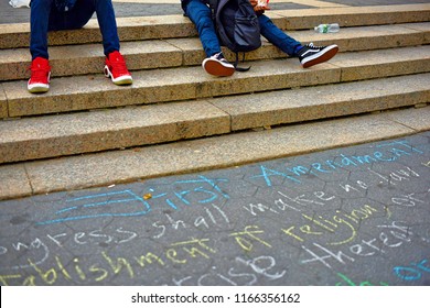 New York, NY; June 2017; People Sit On The Steps Of Union Square With The First Amendment Written In Chalk On The Sidewalk 