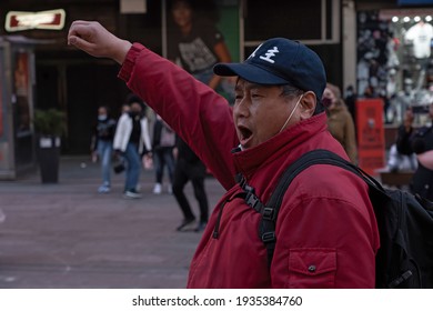 NEW YORK, NY – MARCH 13: Pro Chinese Democracy Activist Chant With A Raise Fist During A China Democracy Party Demonstration At Times Square On March 13, 2021 In New York City.