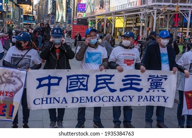 NEW YORK, NY – MARCH 13: Pro Chinese Democracy Activists Holds Banners During A China Democracy Party Demonstration At Times Square On March 13, 2021 In New York City.