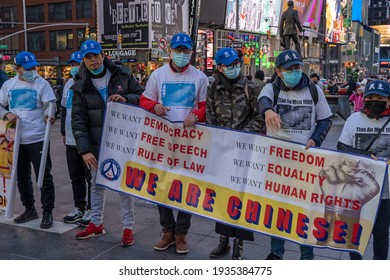 NEW YORK, NY – MARCH 13: Pro Chinese Democracy Activists Holds Banners During A China Democracy Party Demonstration At Times Square On March 13, 2021 In New York City.