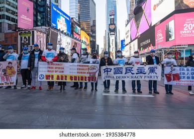 NEW YORK, NY – MARCH 13: Pro Chinese Democracy Activists Holds Banners During A China Democracy Party Demonstration At Times Square On March 13, 2021 In New York City.