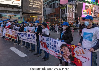 NEW YORK, NY – MARCH 13: Pro Chinese Democracy Activists Holds Banners During A China Democracy Party Demonstration At Times Square On March 13, 2021 In New York City.