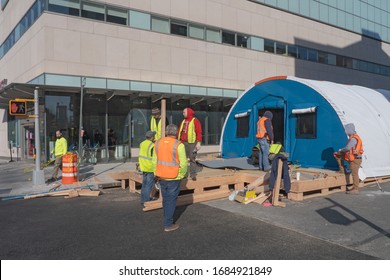 NEW YORK, NY - MARCH 26: Workers Build A Makeshift Triage Tent Outside Mount Sinai Hospital Due To The Coronavirus Outbreak On March 26, 2020 In Astoria Neighborhood Of New York City.