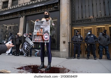 NEW YORK, NY - MARCH 6, 2021: A Protester Wearing Canada Goose Coat Cover With Blood Stands In A Pool Of Blood During A Canada Goose Protest In Front Of Saks Fifth Avenue Flagship Store.