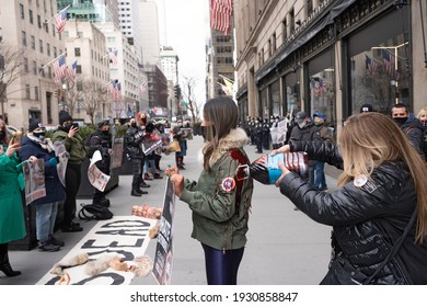 NEW YORK, NY - MARCH 6, 2021: Animal Rights Activists Pours Blood On A Protester Wearing Canada Goose Coat During A Canada Goose Protest In Front Of Saks Fifth Avenue Flagship Store.