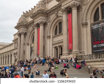 NEW YORK, NY – MAY 18, 2018: Museum Goers And Tourists Rest Outside On The Steps Of The The Met (The Metropolitan Museum Of Art).