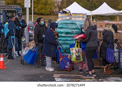 NEW YORK, NY – NOVEMBER 20: People Receive Free Food At A Food Bank Thanksgiving Holiday Event On November 20, 2021 In Queens Borough Of New York City.