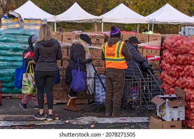 NEW YORK, NY – NOVEMBER 20: People Receive Free Food At A Food Bank Thanksgiving Holiday Event On November 20, 2021 In Queens Borough Of New York City.