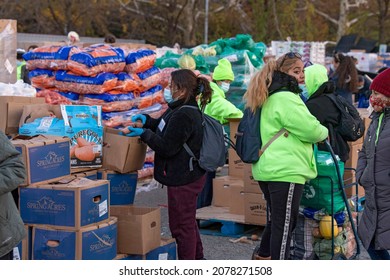 NEW YORK, NY – NOVEMBER 20: People Receive Free Food At A Food Bank Thanksgiving Holiday Event On November 20, 2021 In Queens Borough Of New York City.