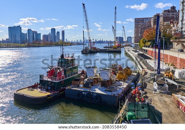 New York, NY - November 23, 2021: Construction of\
the East Midtown Waterfront Esplanade along the East River in NYC.\
This section reuses parts of a temporary roadway used to\
reconstruct the FDR Drive