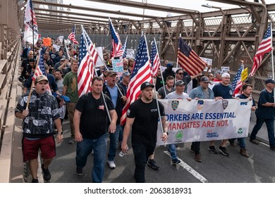 New York, NY - October 25, 2021: Municipal workers of the city march across Brooklyn bridge and rally at City Hall Park against vaccination mandate