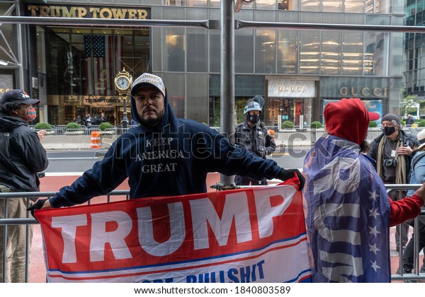 NEW YORK, NY –\
OCTOBER 25: President Trump supporters march along 5th avenue with\
caravan of cars and huge Trump blue, white, black flag on October\
25, 2020 in New York City.