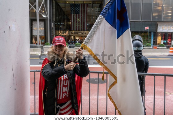 NEW YORK, NY –\
OCTOBER 25: President Trump supporters march along 5th avenue with\
caravan of cars and huge Trump blue, white, black flag on October\
25, 2020 in New York City.