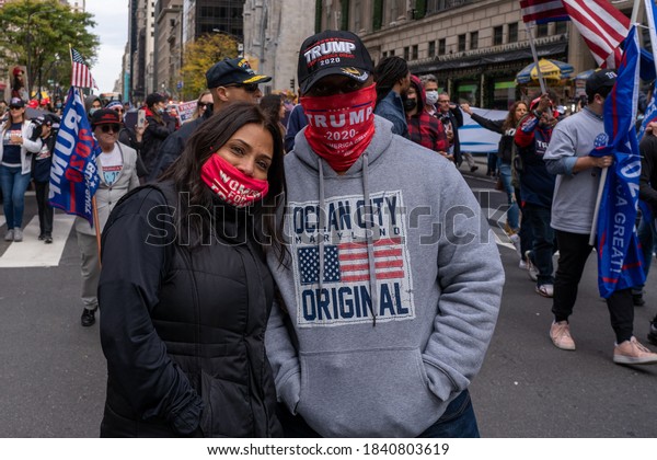 NEW YORK, NY –
OCTOBER 25: President Trump supporters march along 5th avenue with
caravan of cars and huge Trump blue, white, black flag on October
25, 2020 in New York City.
