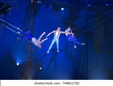 New York, NY - October 29, 2017: Ammed Tuniziani, Adriano DeQuadra, Mauricio Navas performs Flying Trapeze act at Big Apple Circus opening night at Lincoln Center Damrosch Park
