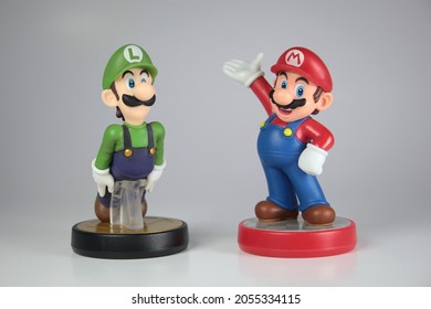 New York, NY - October 9, 2021: Nintendo Super Mario Bros And Super Smash Brothers Series Luigi And Mario Amiibos Isolated