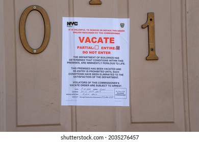 NEW YORK, NY - SEPTEMBER 02: Vacate Sign Seen On Door Of A House Where People Were Killed When Their Basement Apartment Was Flooded By Hurricane Ida's Remnants On September 2, 2021 In New York City.