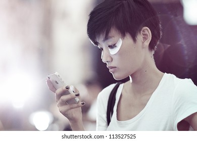 NEW YORK, NY - SEPTEMBER 13: A Model Uses Mobile Phone Backstage At Cynthia Rowley Spring Summer 2013 Fashion Presentation During Mercedes Benz Fashion Week On September 13, 2012 In New York City, USA