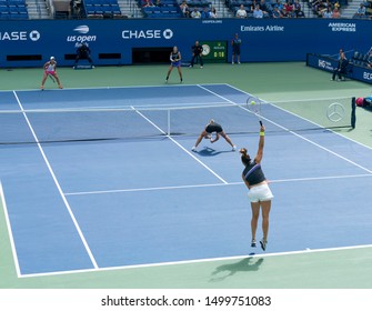 New York, NY - September 8, 2019: Both teams in action during womens doubles final match at US Open at Billie Jean King National Tennis Center