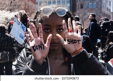 New York, NY / UNITED STATES - 04,20,2018: Student Protester with Don't Shoot Written on her palms.
