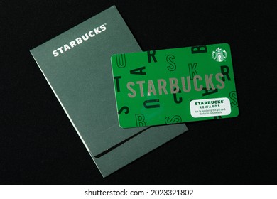 New York, NY, USA 8-9-2021: Starbucks Coffee gift card with matching dark green envelope sleeve. Company name written across in capital letters. The individual cards can hold a maximum value of $500.