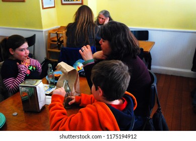 New York, NY, USA April 12 A Family Enjoys Lunch In A Small Cafe In Greenwich Village, New York City