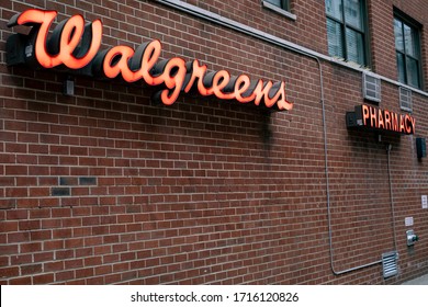 New York, NY / USA - April 19 2020:  Open Walgreens pharmacy store in Manhattan on Upper East Side.  Providing essential services and supplies during COVID-19 pandemic.