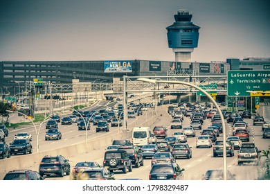 New York, NY / USA - August 15 2020: Traffic Car On The Highway Going To LaGuardia Airport. Air Traffic Control Tower Seen Above Terminals