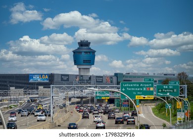 New York, NY / USA - August 15 2020: Traffic Car On The Highway Going To LaGuardia Airport. Air Traffic Control Tower Seen Above Terminals