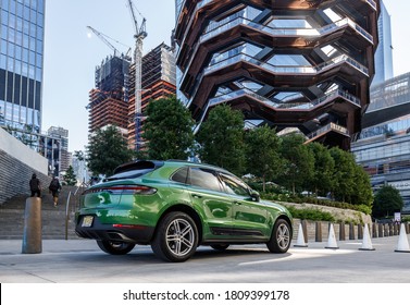 New York, NY / USA - August 1 2020: green suv parked near skyscraper. 