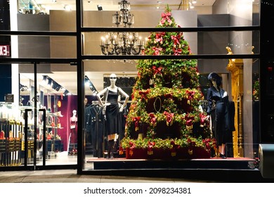 New York, NY USA - December 17, 2021: The World Famous Fashion Boutiques And Designer Shops On Madison Avenue Decorate Their Storefront Windows With Colorful Christmas Themed Decorations Each Winter.