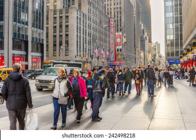 New York, NY, USA - December 27, 2014: Sixth Avenue in Midtown Manhattan packed with Locals and Tourists during the Christmas Holidays. More than 50 million people visit New York every year. 