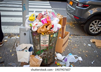 New York, NY, USA - Feb 1, 2021: Trash Can Overflowing With Trash On A Manhattan Sidewalk