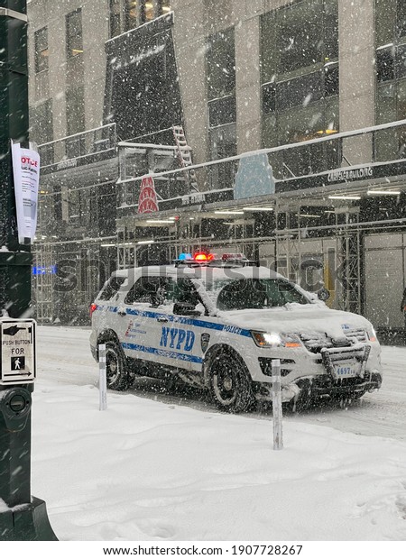 New York, NY\
USA - February 1, 2021: New York City, Snow Covered Police Car in\
Manhattan During Nor\'easter\
Blizzard