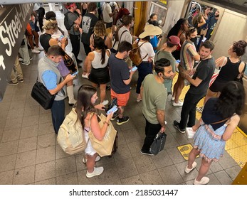 New York, NY USA - July 22, 2022: New York City,  Commuter Crowd Waiting For Subway Train In Summer