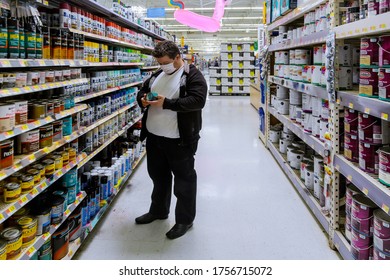 New York, NY USA - JUNE 14, 2020: Man On Mask Shopping On Walmart Local Store Chooses Paint In The Hardware Store With Coronavirus COVID-19