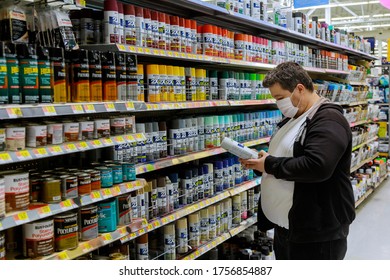 New York, NY USA - JUNE 14, 2020: A Man Wearing A Protective Mask In Buyer Selects Paint In The Store Walmart