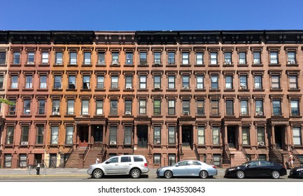 New York, NY USA - June 23, 2019 - A row of historic brownstones on Lenox Avenue in Harlem