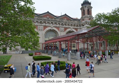 New York, NY, USA - June 28, 2015: Tourists going into Ellis Island entrance 