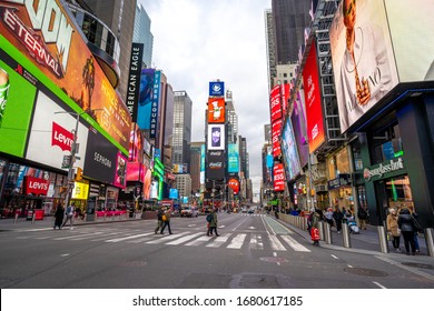 New York, NY / USA - March 16 2020:  People Crossing Road At Times Square, Day Light